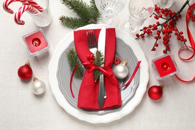 Photo of Festive table setting with beautiful dishware and Christmas decor on white background, flat lay