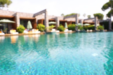 Photo of Luxury resort with outdoor swimming pool and sun loungers on sunny day, blurred view