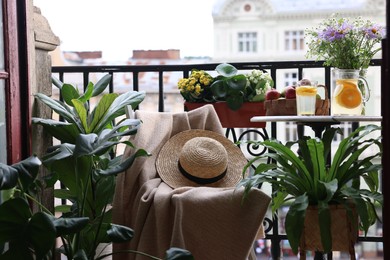 Photo of Relaxing atmosphere. Stylish furniture surrounded by beautiful houseplants on balcony