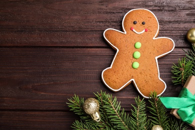 Photo of Flat lay composition with gingerbread man on wooden table, space for text