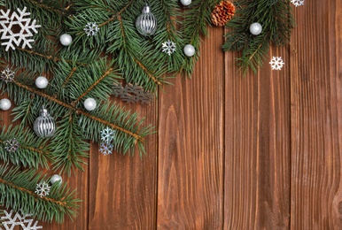 Photo of Christmas decorations on wooden background, top view. Space for text