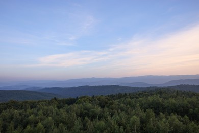 Photo of Picturesque view of mountains covered with forest under sky