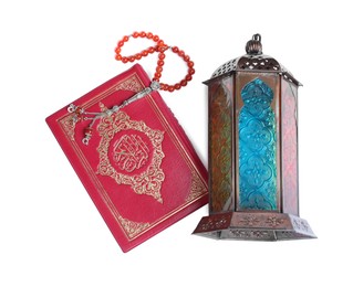 Photo of Decorative Arabic lantern, Quran and misbaha on white background, top view