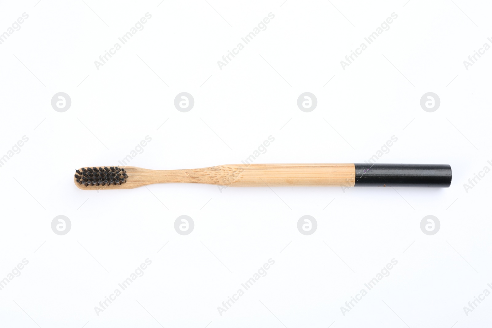 Photo of Bamboo toothbrush with charcoal bristle isolated on white, top view