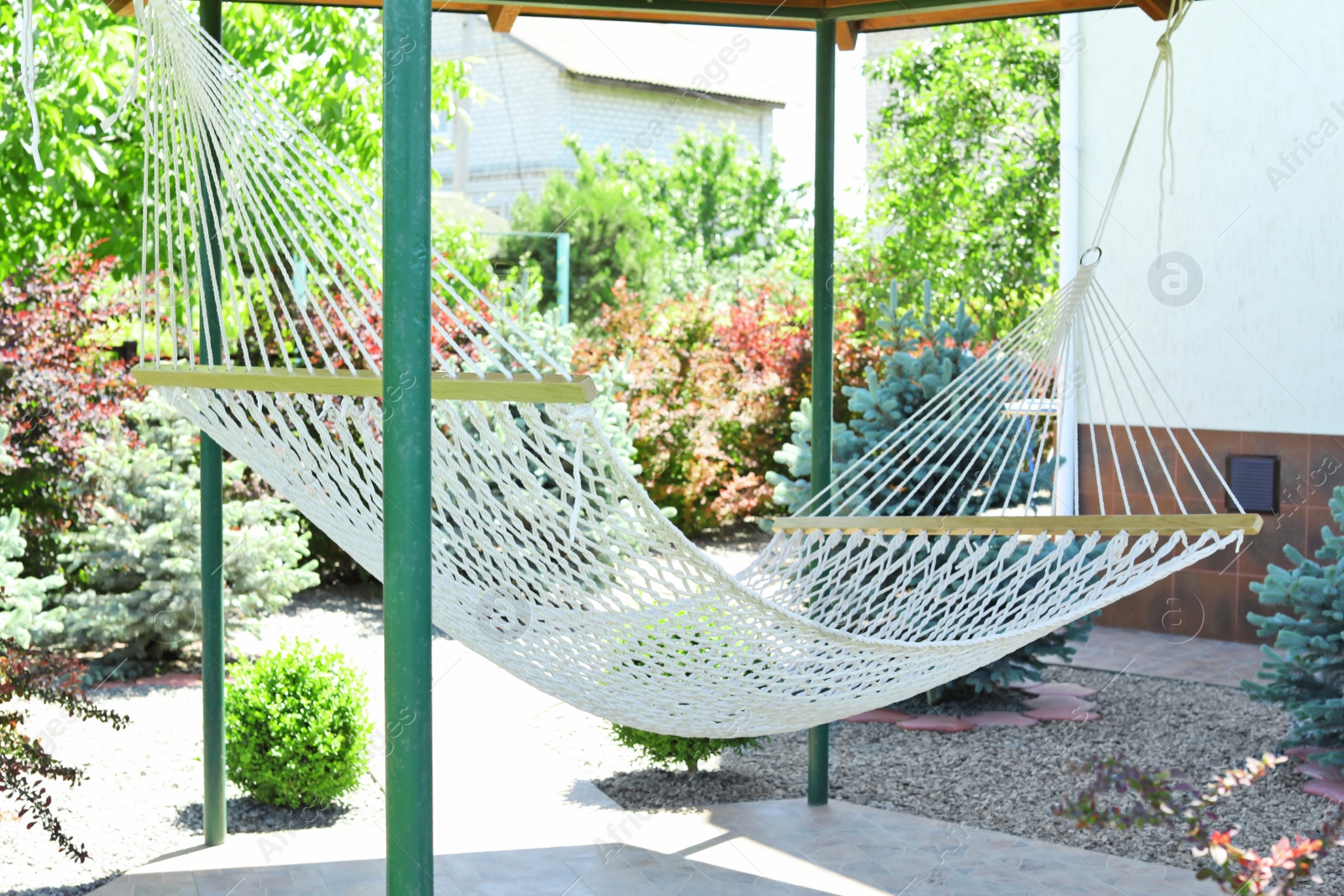 Photo of Beautiful English style garden with comfortable hammock on sunny day