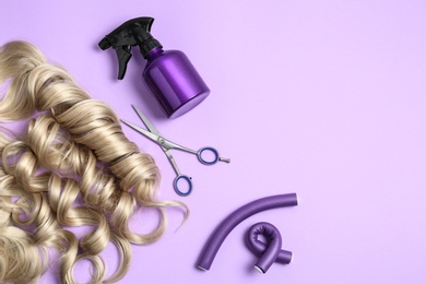 Photo of Flat lay composition with hair locks and tools on color background. Space for text