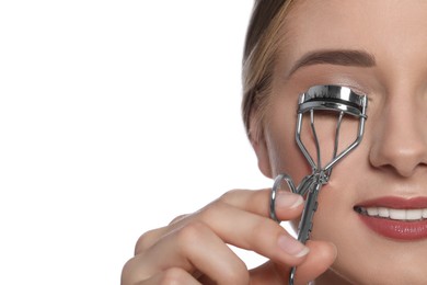Photo of Young woman using eyelash curler on white background, closeup