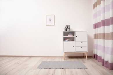 Photo of Interior of modern child room with cabinet. Space for text