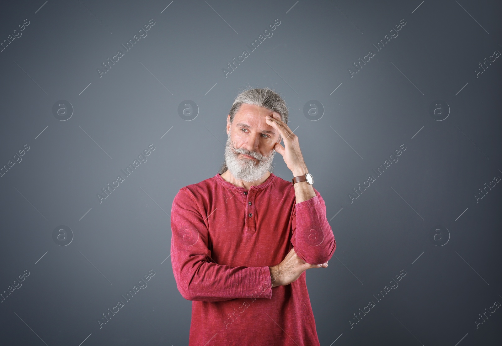 Photo of Portrait of handsome mature man on color background