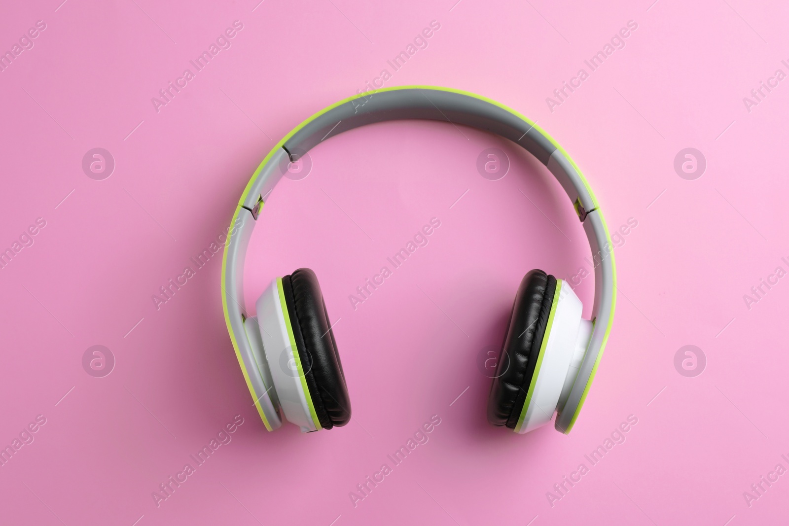 Photo of Wireless headphones on color background, top view