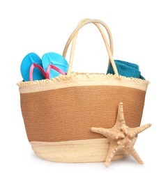 Photo of Stylish straw bag with beach objects and starfish isolated on white