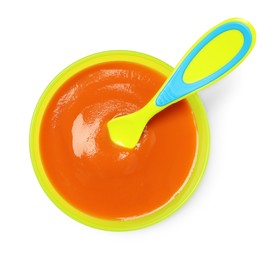 Photo of Delicious baby food and spoon in bowl isolated on white, top view