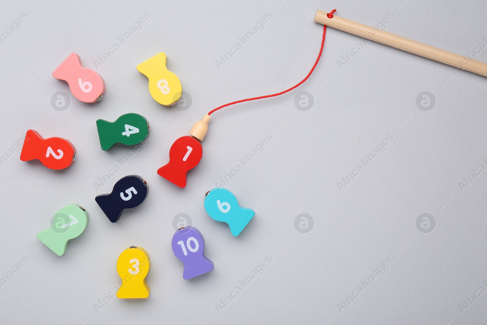 Photo of Educational game Fishing for Numbers on light grey background, flat lay. Space for text