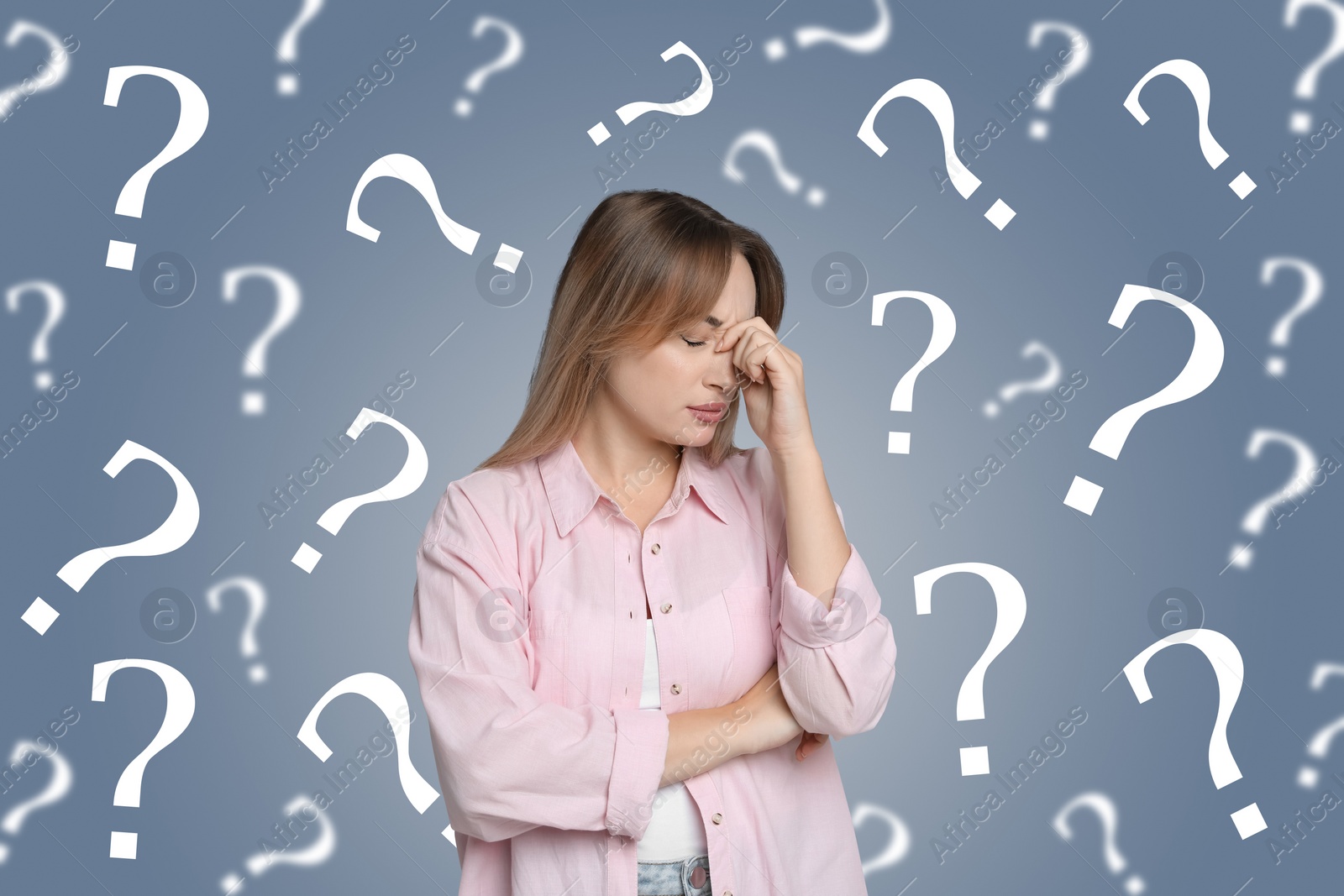 Image of Amnesia concept. Woman surrounded by question marks trying to remember something on color background