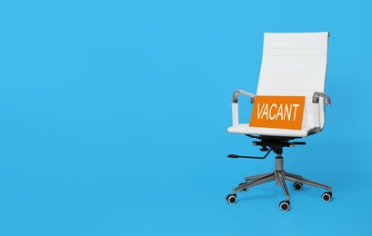 Image of White office chair with sign VACANT on light blue background, space for text