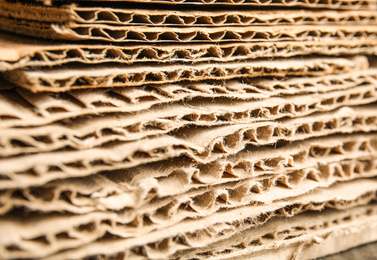 Photo of Sheets of brown corrugated cardboard as background, closeup