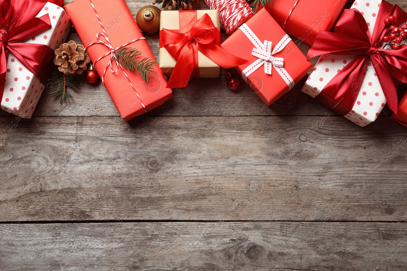 Photo of Beautiful composition with gift boxes and Christmas decorations on wooden background, top view