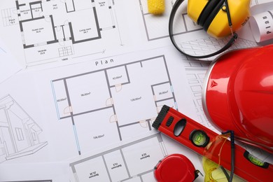 Photo of Flat lay composition with building level and other construction tools on papers