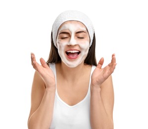 Young woman with headband washing her face on white background