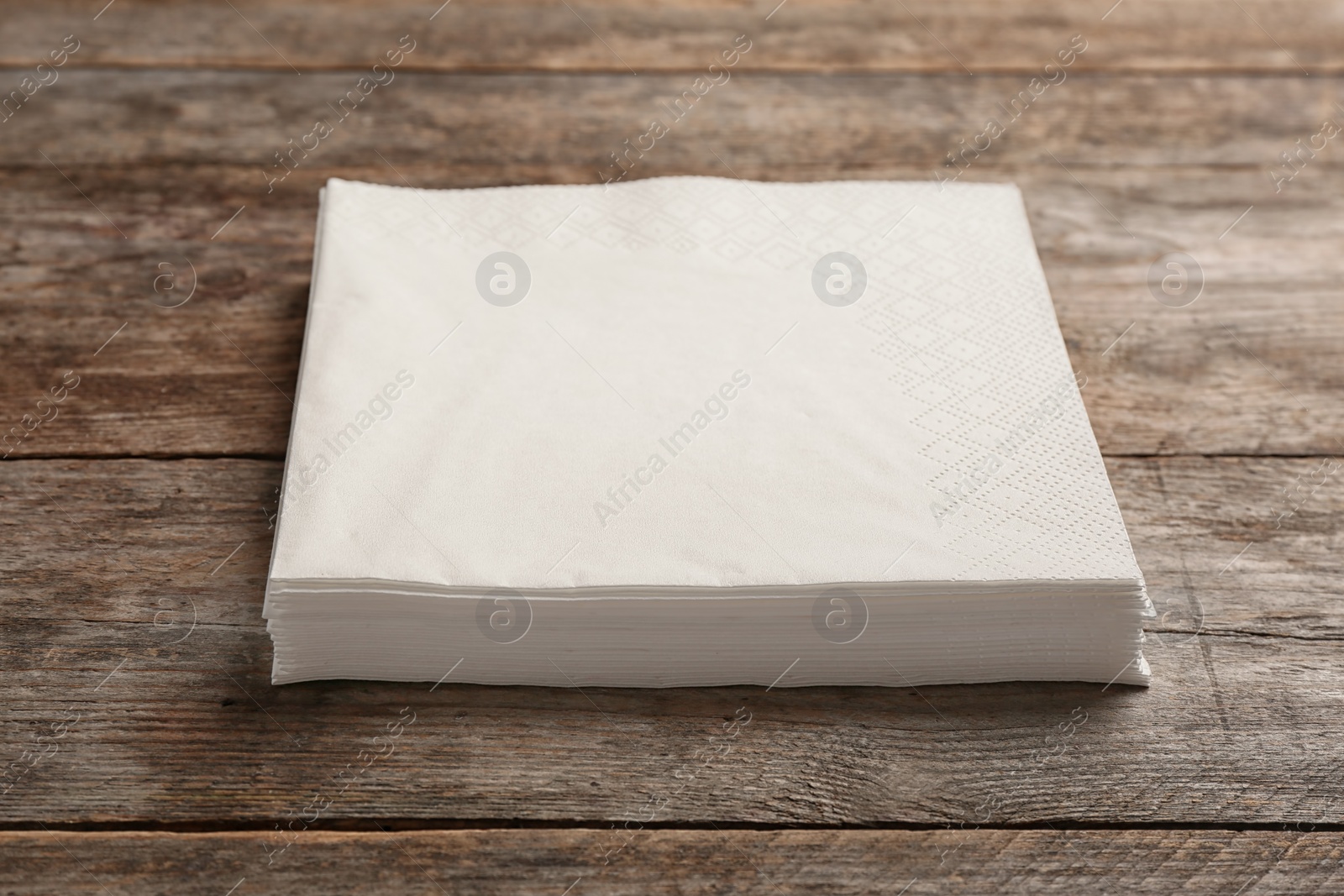 Photo of Clean napkins on wooden background. Personal hygiene