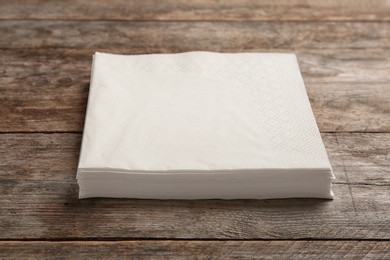 Photo of Clean napkins on wooden background. Personal hygiene