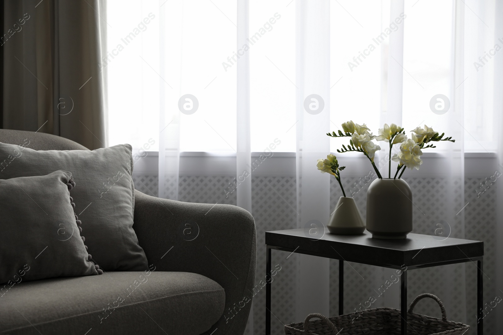 Photo of Beautiful spring freesia flowers on table in room