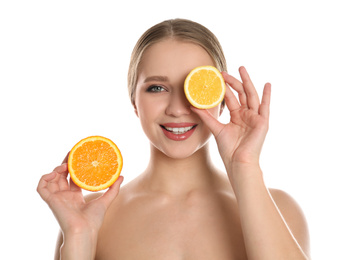 Young woman with cut orange and lemon on white background. Vitamin rich food