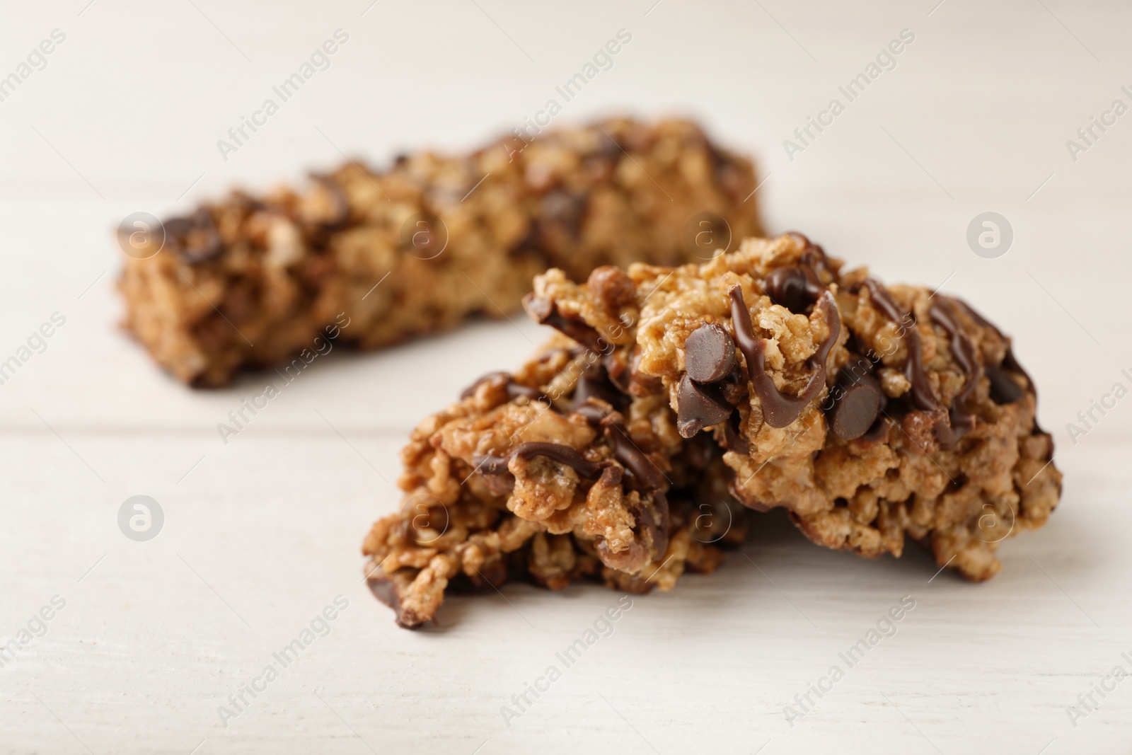 Photo of Tasty protein bars on white table. Healthy snack