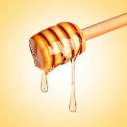 Image of Natural honey dripping from dipper on pale yellow background