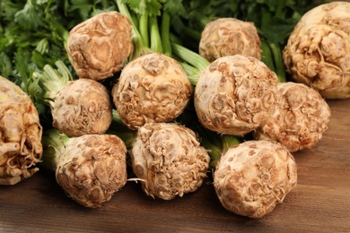 Fresh raw celery roots on wooden table, closeup