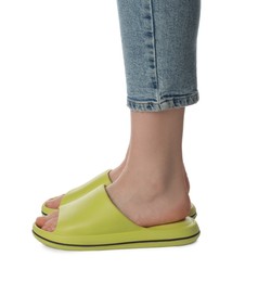 Photo of Woman in green slippers on white background, closeup