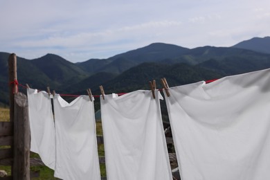 Washing line with clean laundry and clothespins in mountains