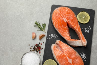 Photo of Fresh salmon and ingredients for marinade on light grey table, flat lay. Space for text