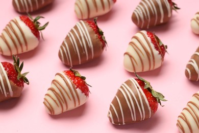 Delicious chocolate covered strawberries on pink background