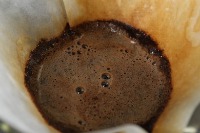 Photo of Paper filter with aromatic drip coffee, closeup