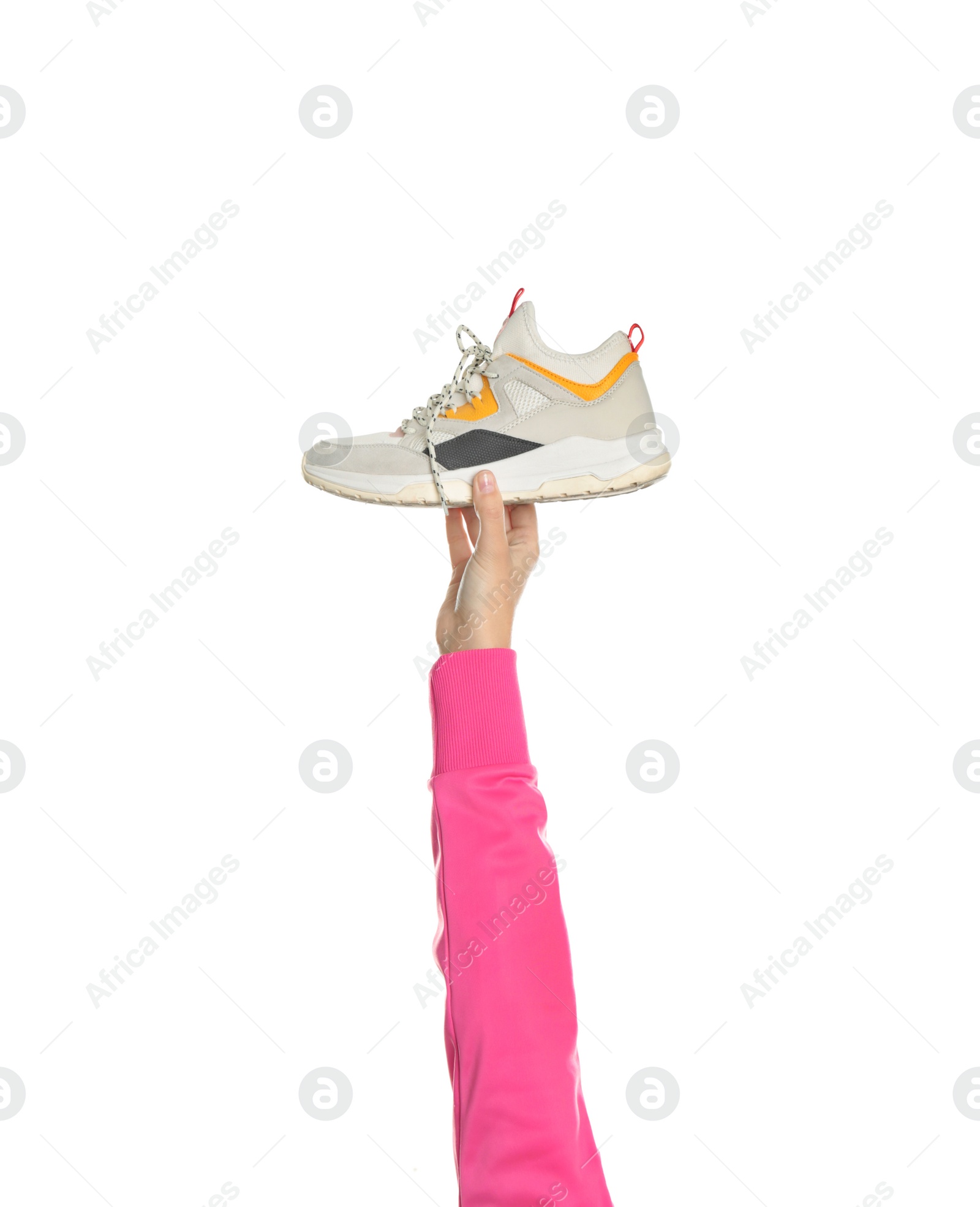 Photo of Young woman holding comfortable shoe on white background, closeup