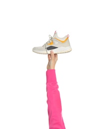 Photo of Young woman holding comfortable shoe on white background, closeup