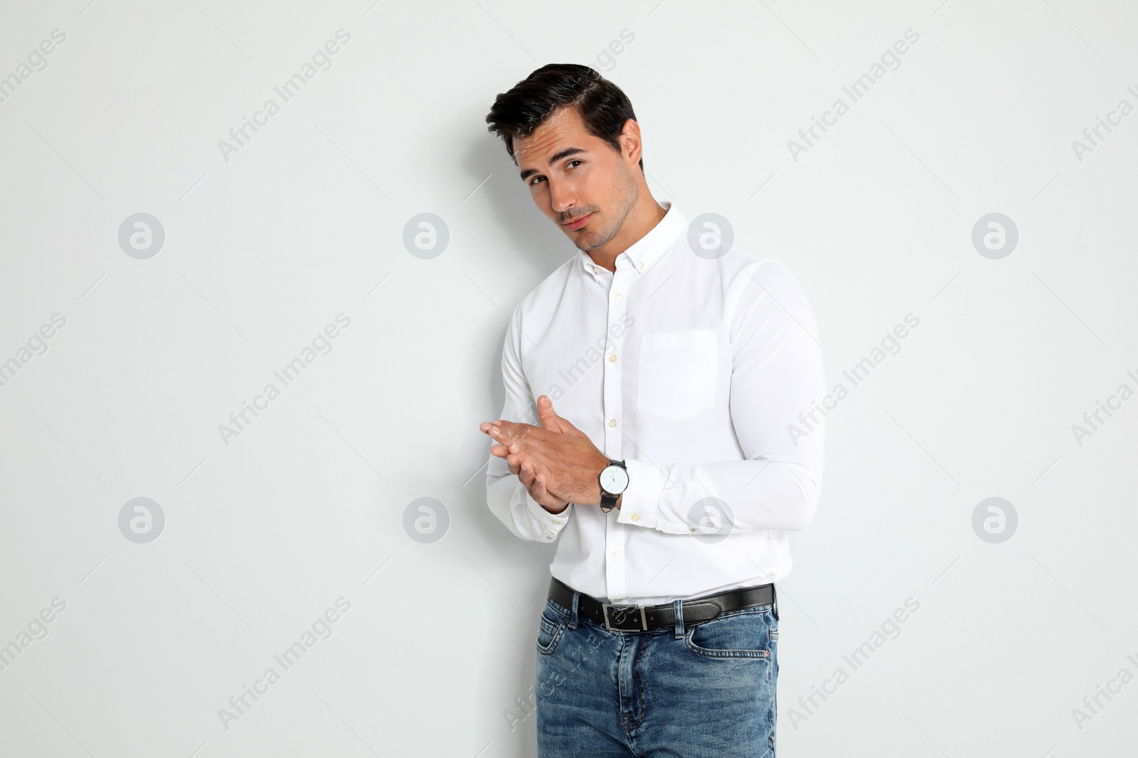 Photo of Portrait of handsome young man on light background