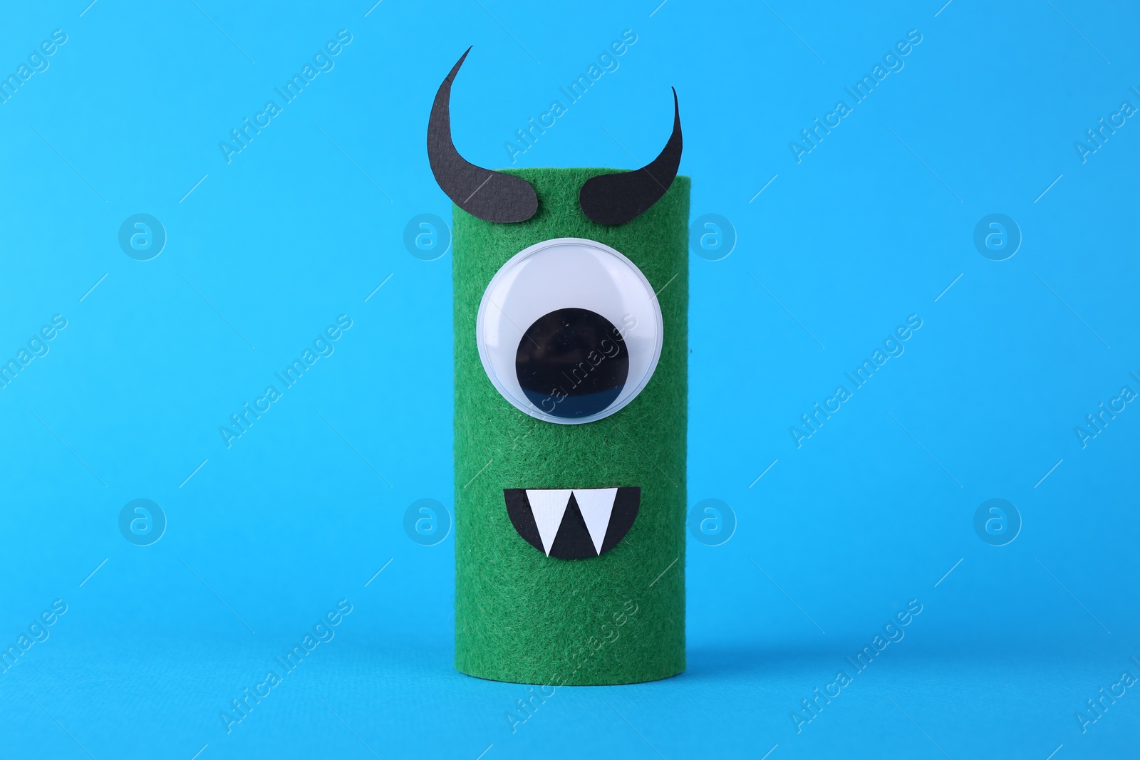 Photo of Spooky monster on light blue background. Handmade Halloween decoration