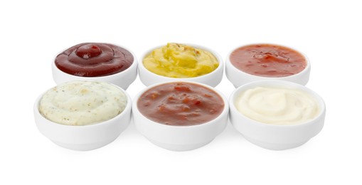 Many different sauces in bowls on white background