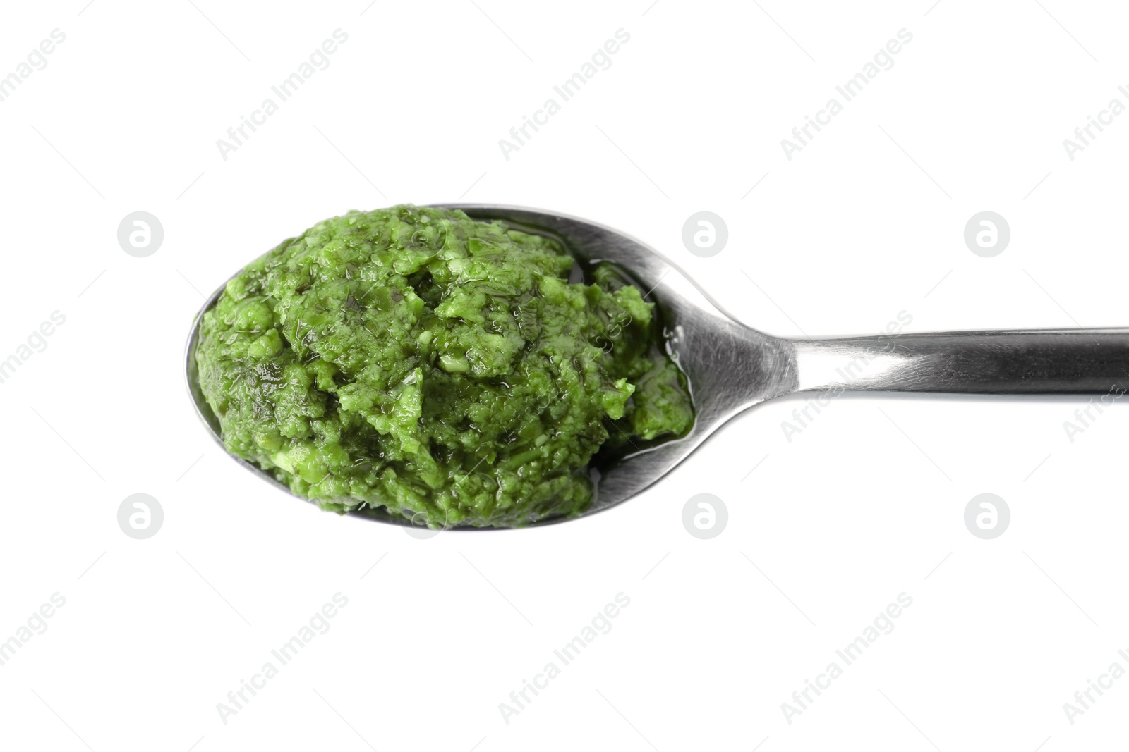 Photo of Spoon of tasty pesto sauce isolated on white, top view