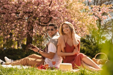 Photo of Happy couple having picnic in park on sunny day