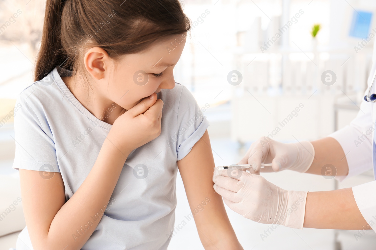 Photo of Doctor vaccinating little girl in hospital