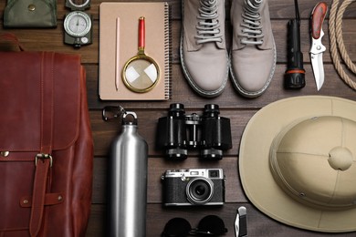 Photo of Flat lay composition with different safari accessories on wooden background