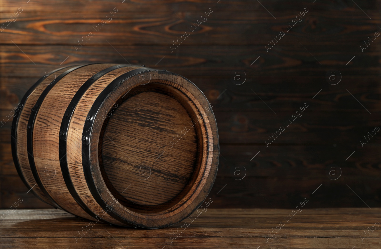 Photo of Wooden barrel on table, space for text