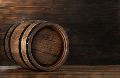 Wooden barrel on table, space for text