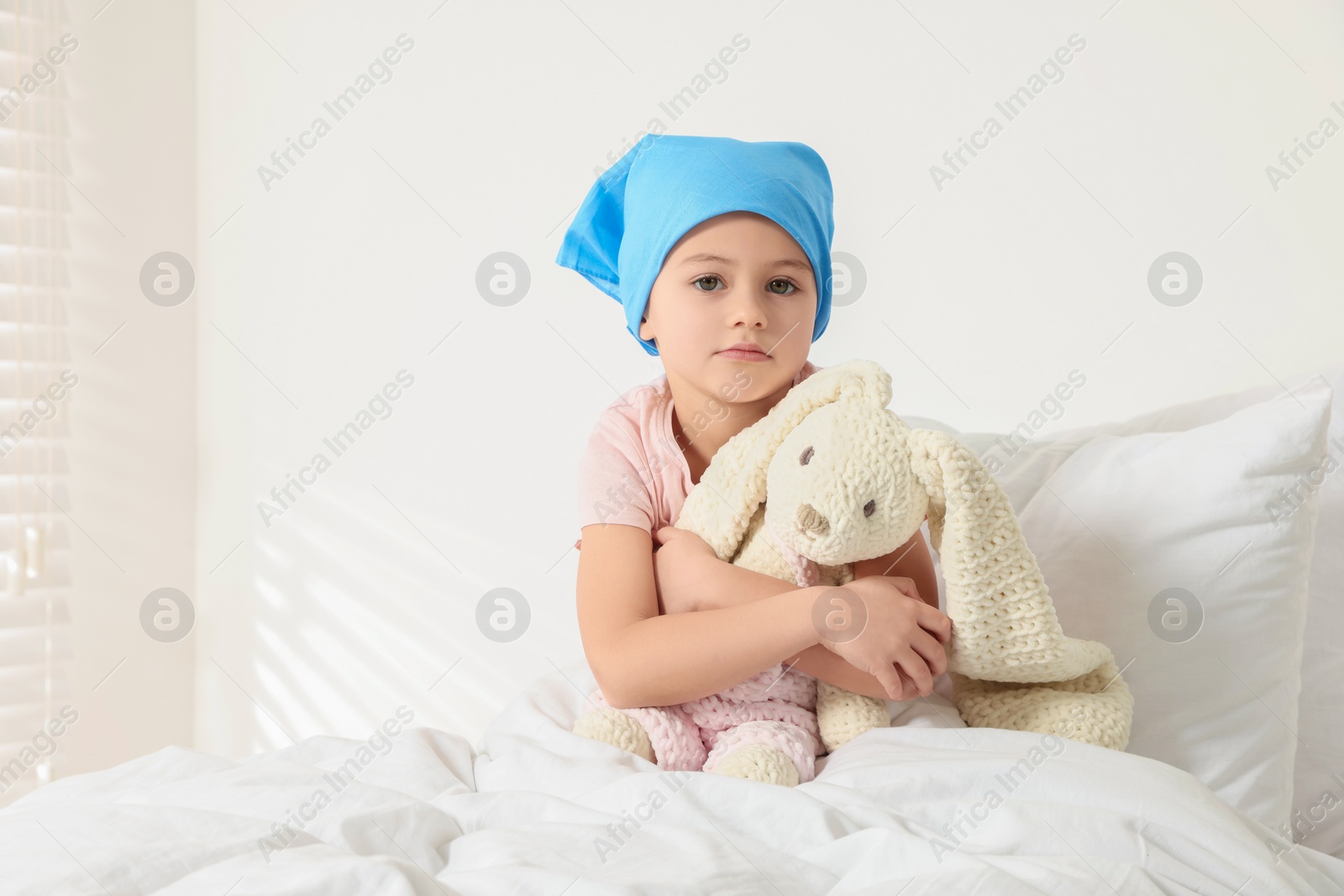 Photo of Childhood cancer. Girl with toy bunny in hospital