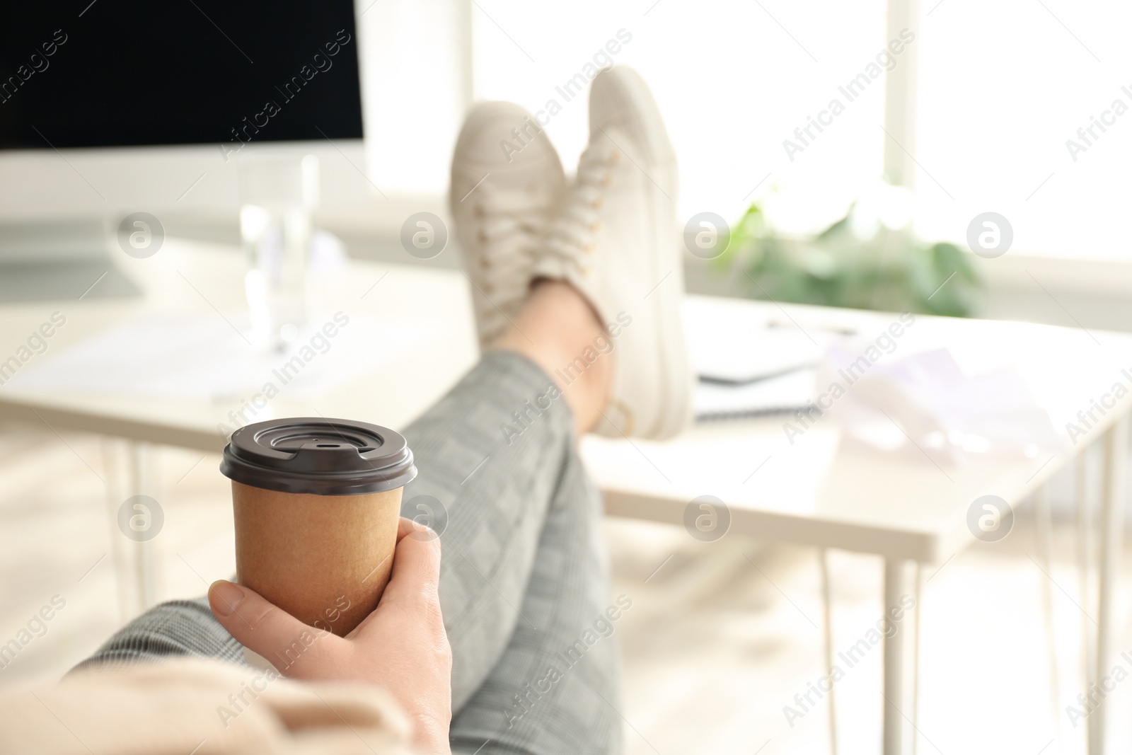 Photo of Lazy overweight worker with feet on desk in office, closeup