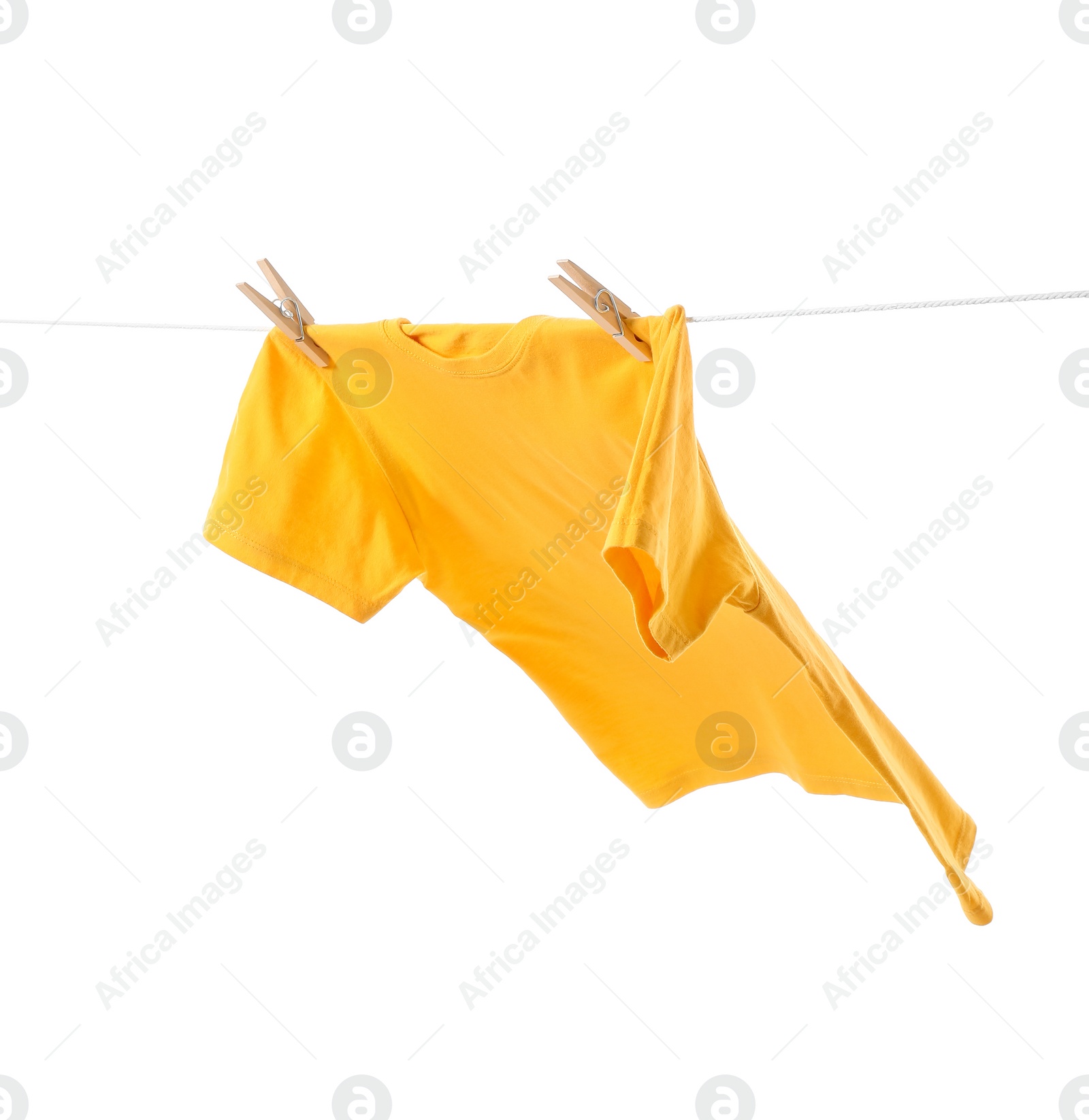 Photo of One yellow t-shirt drying on washing line isolated on white