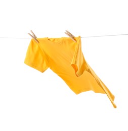 Photo of One yellow t-shirt drying on washing line isolated on white